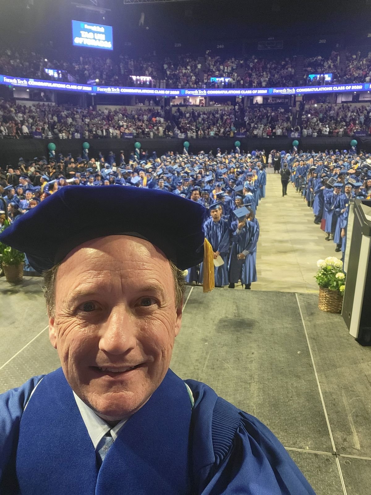 Chris Parker in academic regalia at a Forsyth Tech graduation ceremony
