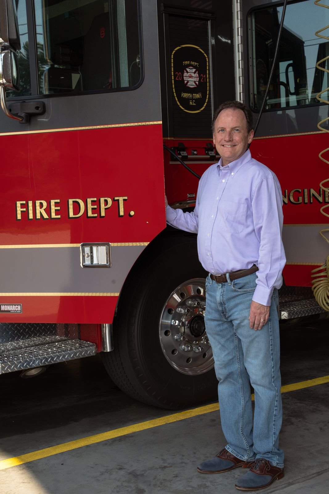Chris Parker standing beside a fire engine